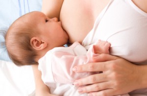 Breastfeeding. Young mother and 1.5 month baby